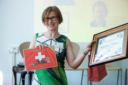 Carmen Müller accepts a certificate of appreciation from Columbia University and a box of Swiss chocolates. She has led the Berlin Consortium for German Studies for the last thirty years.